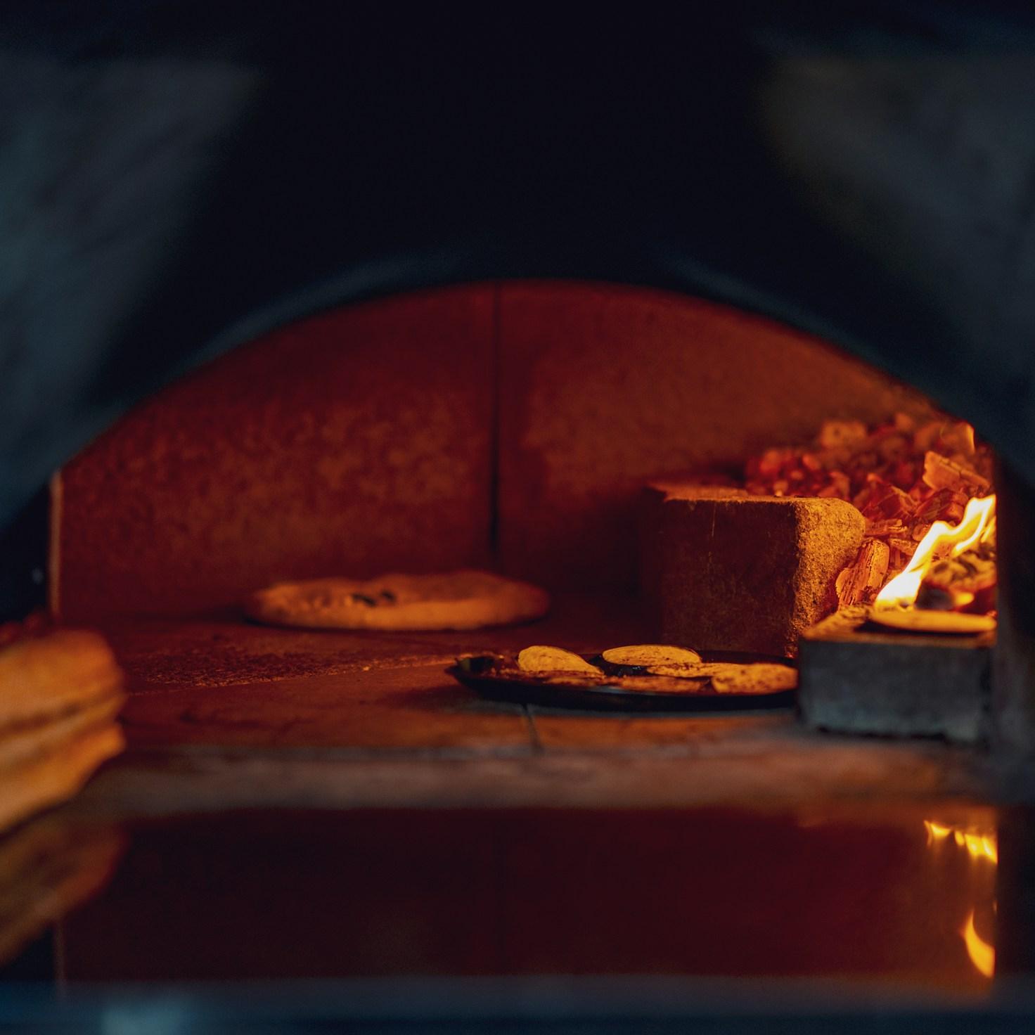 Diverse group of community members sharing a meal together, showcasing the social bonds formed through collaborative cooking